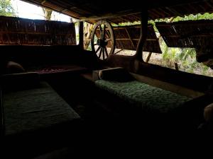 a dark room with a bed and aokedokedokedoked at Habarana Eco Lodge & Safari in Habarana