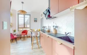 a kitchen with a sink and a table with chairs at 1 Bedroom Stunning Apartment In Melrand in Melrand