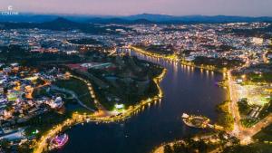 an aerial view of a city by the water at night at Hôtel Colline in Da Lat