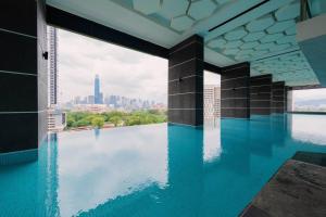 a swimming pool with a view of the city at Muji Home Lavile KL Sunway Velocity 双威永乐城中文房东Pool in Kuala Lumpur