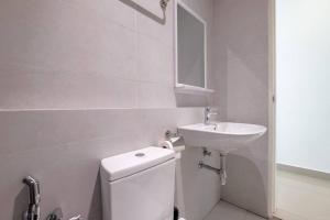 a white bathroom with a sink and a toilet at Muji Home Lavile KL Sunway Velocity 双威永乐城中文房东Pool in Kuala Lumpur