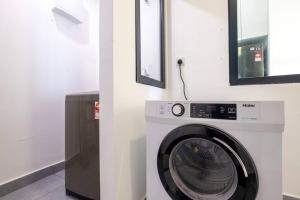 a washing machine in a room next to a wall at Muji Home Lavile KL Sunway Velocity 双威永乐城中文房东Pool in Kuala Lumpur