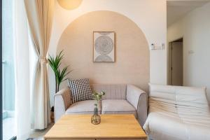 a living room with a couch and a table at Muji Home Lavile KL Sunway Velocity 双威永乐城中文房东Pool in Kuala Lumpur