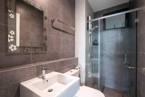 a bathroom with a sink and a shower and a toilet at Muji Home Lavile KL Sunway Velocity 双威永乐城中文房东Pool in Kuala Lumpur