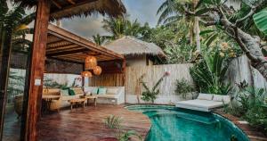 a villa with a swimming pool and a patio at Majo Private Villas in Gili Trawangan