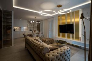 un soggiorno con un divano, un tavolo e una televisione di Villa Sorriso a Sveti Filip i Jakov (Santi Filippo e Giacomo)