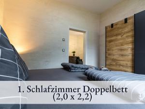 a bedroom with two beds and a sliding door at Familienfreundliche Ferienwohnung mit großem Garten, Spielplatz, privatem Badefass & Sauna in Wendisch Rietz