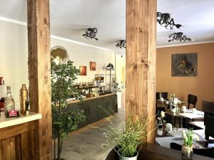 a restaurant with plants in the middle of a room at Le petit Palais - Hotel/Pension in Bad Suderode
