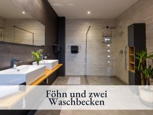 a bathroom with two sinks and a shower at Fewo Lake I bis 5 Pers I mit Terrasse I Garten mit Spielplatz I inkl Badefass in Wendisch Rietz