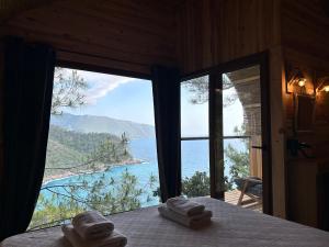 a room with a view of the ocean with towels at Kabak Ütopya Suites in Faralya