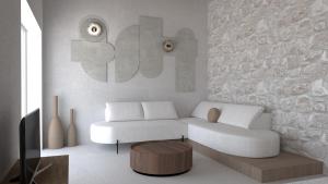 sala de estar con sofá blanco y mesa en Fos Collection Villas & Residences, en Platis Yialos Sifnos