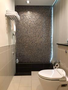 a bathroom with a toilet and a shower at Backpackers Cozy Apartment Bukit Bintang in Kuala Lumpur
