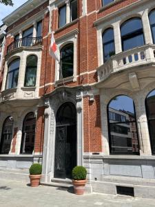 a building with a flag in front of it at Boutique Hotel Marie Marie in Dendermonde