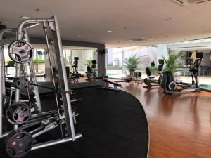 a gym with treadmills and other equipment in a building at Backpackers Cozy Apartment Bukit Bintang in Kuala Lumpur