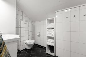 a white bathroom with a toilet and a sink at 3 Bedroom Appartment Close To The Technologypark and University in Kongsberg