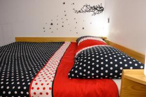 a bed with polka dot pillows on it at Apartman Karolina in Zagreb
