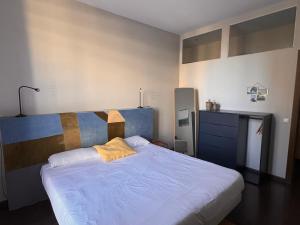 a bedroom with a large bed with a yellow pillow at The Vintage Rentals in Barcelona