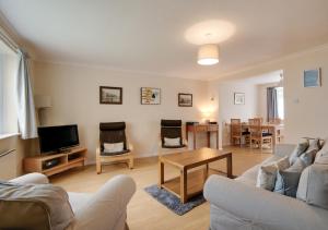 a living room with a couch and a table at Brock Cottage in Instow