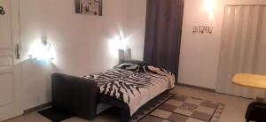 a bedroom with a bed and a chair and lights at Studio Bonne Nuit in Bourg-Saint-Bernard