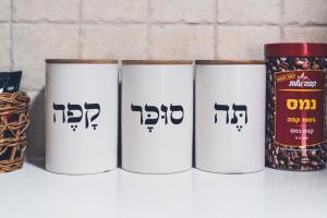 a group of three white cups sitting on a counter at Mellow Bay in Eilat