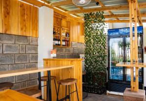 a bar in a restaurant with a green wall at Primeland Hotel in Moshi