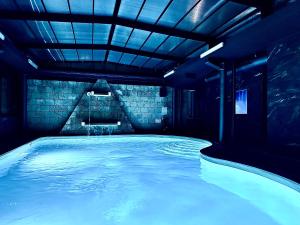 Hotel Michelangelo Palace & SPA في تيرني: حمام سباحة مع أضواء زرقاء في الغرفة