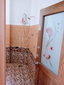 a bathroom with a shower covered indust at Area 51 Apartment in Mirissa