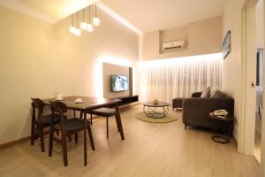 a living room with a table and a couch at Crown Regency Serviced Suites in Kuala Lumpur