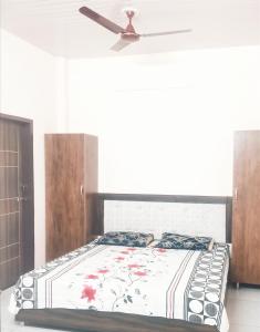 a bedroom with a bed with a ceiling fan at SHUBHAM VILLA -- Super Deluxe Rooms -- LPU Law Gate in Phagwāra