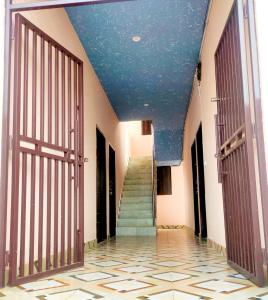 an empty hallway with a blue ceiling and stairs at SHUBHAM VILLA -- Super Deluxe Rooms -- LPU Law Gate in Phagwāra