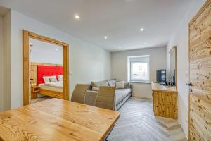 a living room with a couch and a bed at Apartments Viktor in Rateče