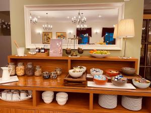 a shelf with bowls and other dishes on it at Hotel Delalut in Ravne na Koroškem