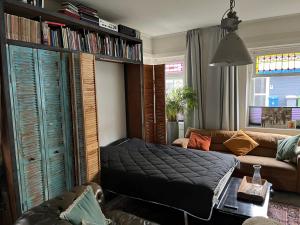 a living room with a bed and a couch at City centre apartment in Apeldoorn