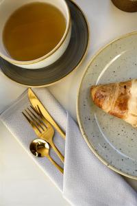 a table with a plate of food and a cup of tea at Heritage Villa Nobile in Dubrovnik