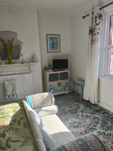 a living room with a couch and a tv at Harbour View B&B in Bridlington