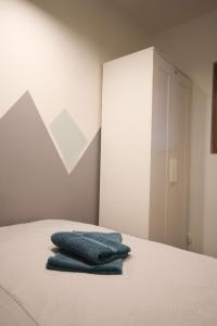 a bedroom with a bed with two blue towels on it at Przerwa W Górach in Karpacz