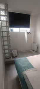 a small room with a bed and a window at Travel and Holidays San Nicolas in San Sebastián de los Reyes