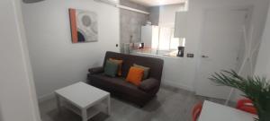 a living room with a couch and a table at Travel and Holidays San Nicolas in San Sebastián de los Reyes
