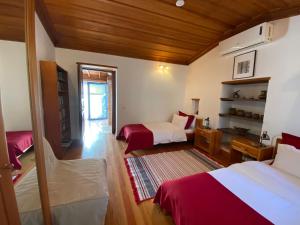 a bedroom with two beds and a room with a table at Goldsmith House in Selçuk