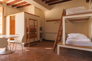 a room with two bunk beds and a table at Can Traver de Besalú in Maia de Montcal