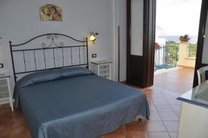 a bedroom with a bed with a blue blanket on it at Verdemare in Macari