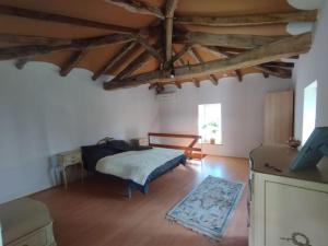 a bedroom with a bed in a room with wooden floors at Cottage chaleureux au calme 