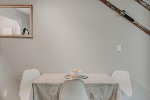 a table with chairs and a candle on it at 45SW-Fireplace-Dishwasher-Washer Dryer-Sleeps 4 condo in Glacier
