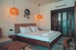 a bedroom with a bed and a table and a couch at Beach 222 Oludeniz in Fethiye