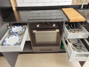 a kitchen with a stove and dishes in it at Cánovas 21 in Carballino