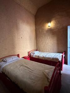 a bedroom with two beds in a room with a window at Riad Nkob in Nkob +38 photos