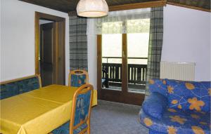 a bedroom with a bed and a couch and a window at Ferienwohnung Im Bauernhof in Fusch an der Glocknerstraße