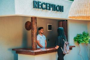 a man and a woman standing outside of a restaurant at Beach 222 Oludeniz in Fethiye