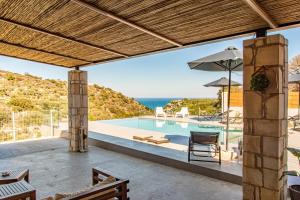 a swimming pool with a view of the ocean at Canyon 2 villa with private pool in Rethymno Town