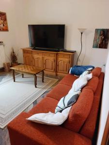 a living room with a couch and a tv at Deluxe Appartament near Racetrack 110 mq 4-5 People in Imola